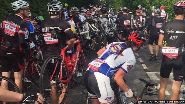 Cyclists carry their bikes