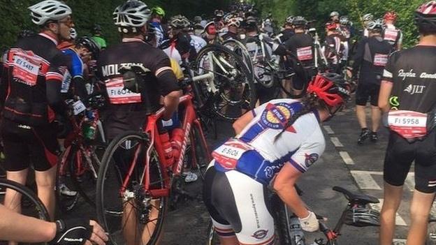 Cyclists carry their bikes