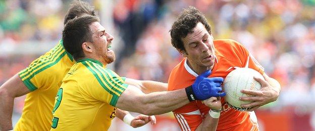 Donegal's Paddy McGrath gets to grips with Orchard forward Jamie Clarke at the Athletic Grounds