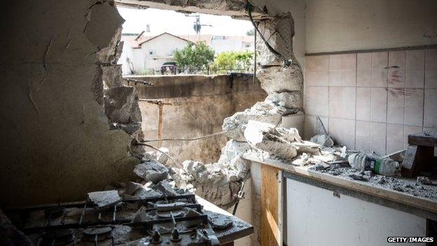 A hole, allegedly caused by a Hamas rocket, is seen in an Israeli home in Sderot, Israel, 21 July 2014