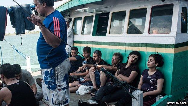 Asylum seekers are seen resting on a boat on May 12, 2013 in Bali, Indonesia.