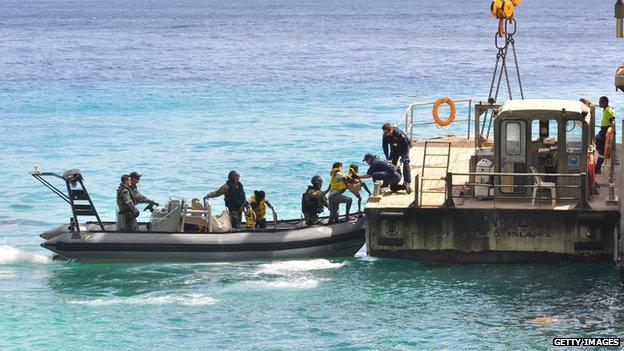 Refugees are removed from a boat headed for Christmas Island, 2012