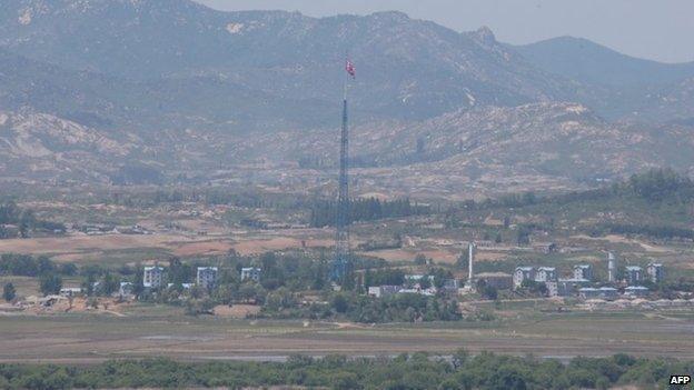 A North Korean flag flutters in the propaganda village of Gijungdong in the Demilitarized Zone dividing the two Koreas as seen from a South Korean observation post in Paju on May 20, 2015.