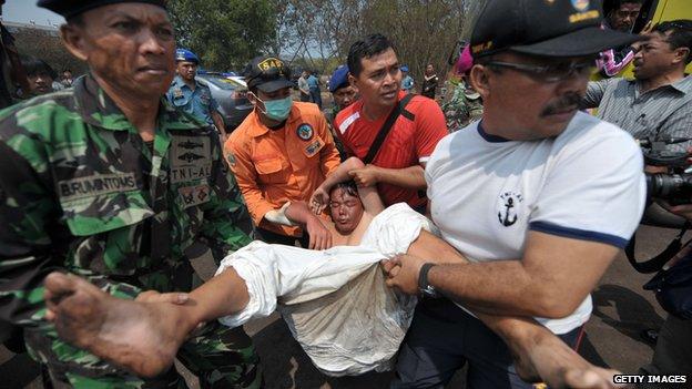 Indonesian rescue teams evacuate a sick asylum-seeker at Merak seaport, on August 31, 2012 after being rescued with other asylum seekers and transferred from an Australian navy and a commercial ship after their boat sunk.