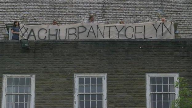 Protestors on Pantycelyn roof