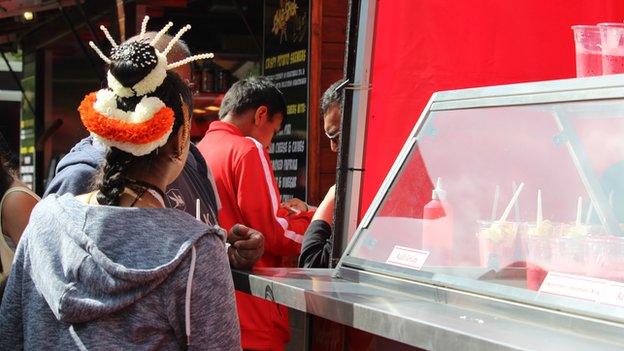 People wait in a queue for falooda