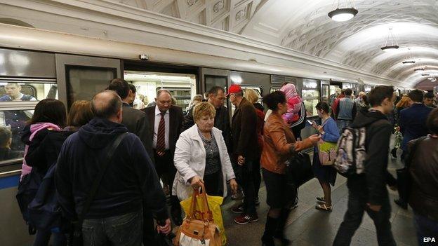 Commuters alighting from a Moscow metro train