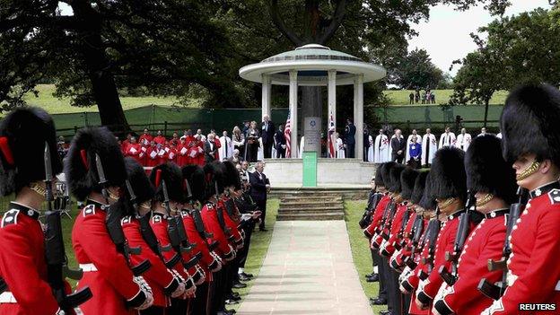 Soldiers march past a Magna Carta memorial