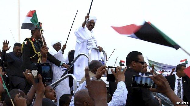 Omar al-Bashir is welcomed by supporters at Khartoum airport