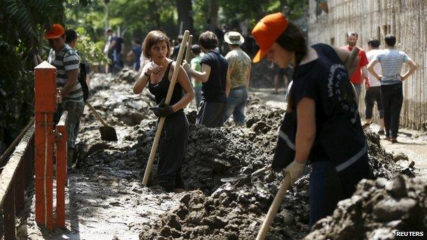 Volunteers clean debris at the zoo in Tbilisi, Georgia, on 15 June 2015.