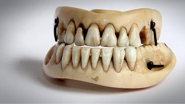 Denture with human front teeth