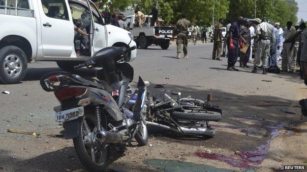 Security officers stand at the site of a suicide bombing in Ndjamena, Chad, 15 June 2015