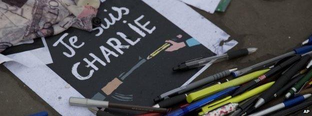 Pens and pencils lay in a circle around "I am Charlie" posters in Trafalgar Square, London, on 9 January 2015