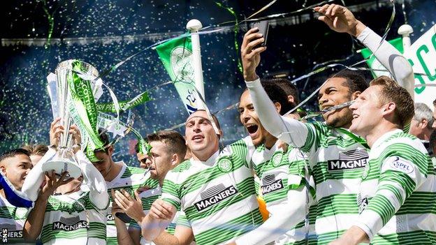 Celtic players celebrating with the Scottish Premiership trophy