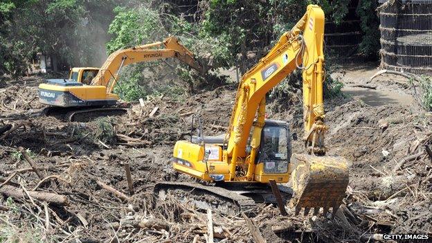 Excavators work at a flooded zoo in the Georgian capital Tbilisi on 16 June 2015.