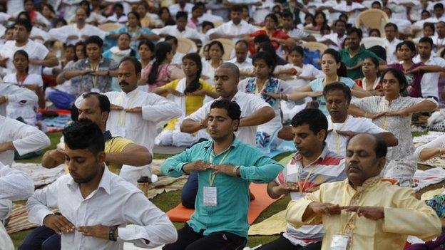 Yoga enthusiasts perform exercises as they participate in a prelude to the International Yoga Day at the Art of Living headquarters on the outskirts of Bangalore, India, Saturday, June 13, 2015