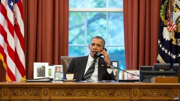 President Barack Obama talks on the phone in the Oval Office at the White House - 28 September 2013