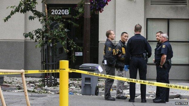 Police standing near debris