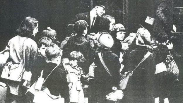 A black and white photo of several children 
