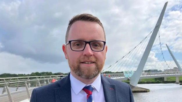 DUP MLA Gary Middleton standing near the Peace Bridge