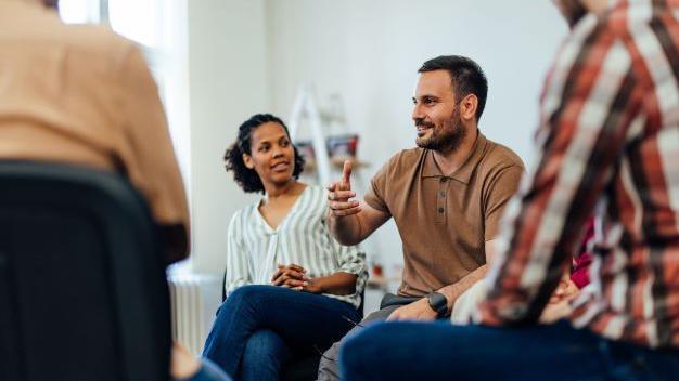 Group of people sat talking