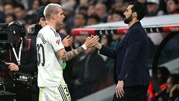 Alvaro Arbeloa shakes hands with Franco Mastantuono as he comes off the pitch during a Real Madrid game