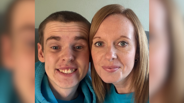 Alma is pictured next to her son. Caleb is on the left of the picture with short dark hair. His mum has long light brown hair. Bot are wearing turquoise tops.