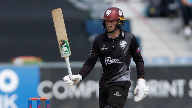 Lewis Goldsworthy raises his bat to acknowledge his second List A century