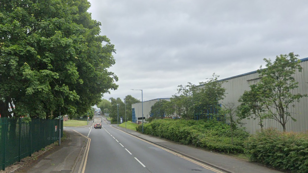 Dartmouth Road, an industrial street lines with green trees and bushes