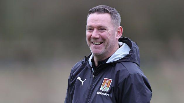 Kevin Nolan smiling wearing a Northampton Town jacket