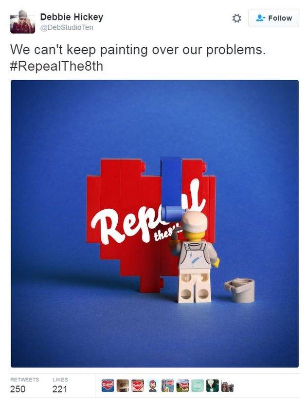 Lego figures with mural and slogan: 'We can't keep painting over our problems'