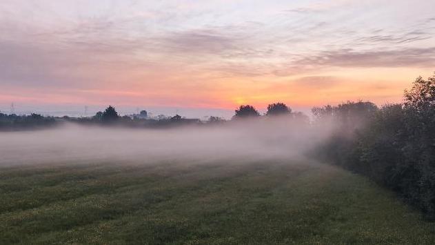 SUNDAY - Mist over a field in Bicester under a pink sky