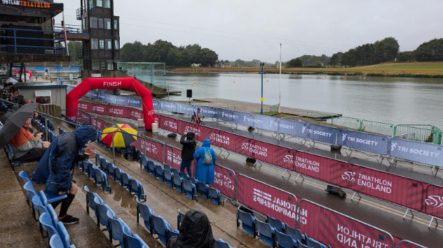 Fans at a seating area next to a lake at the water sports venue