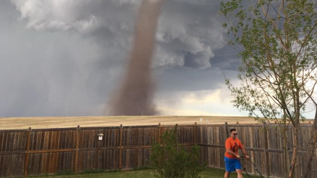 Cecilia Wessels' photo of her husband Theunis mowing a lawn with a tornado behind him