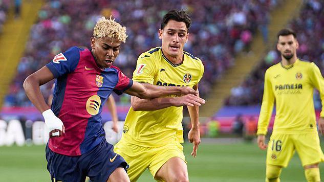 Barcelona's Yamine Yamal competing for the ball with Villarreal's Sergi Cardona during a La Liga match last season.