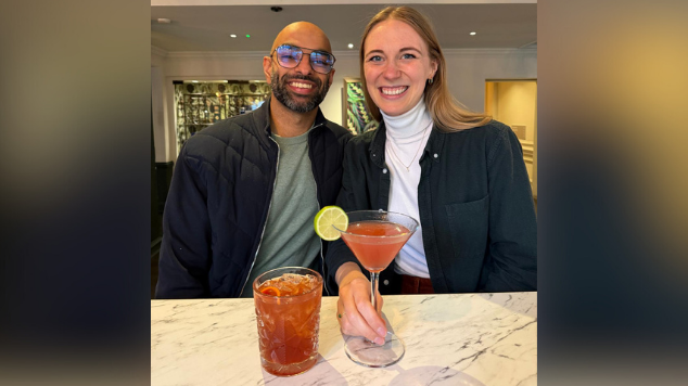 Nicky and Kish Patel smiling at the bar with cocktails after the auction at The Casle Hotel.