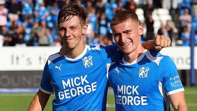 Harry Leonard (left) and Ben Woods (right) all smiles and arm in arm after Saturday's win over Mansfield