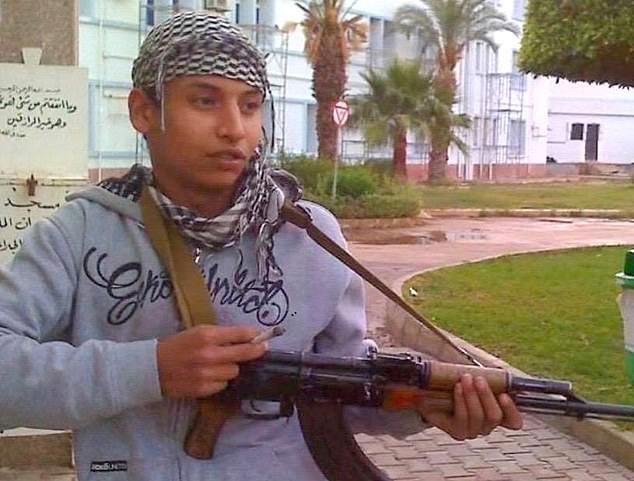 Khairi Saadallah holding gun in Libya