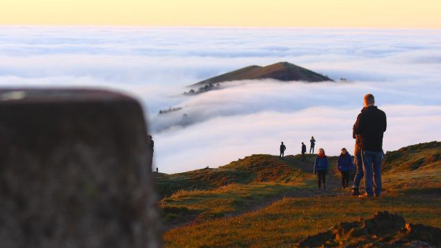 Walkers are on top of the hills as the peaks can be seen above the cloud on Friday.