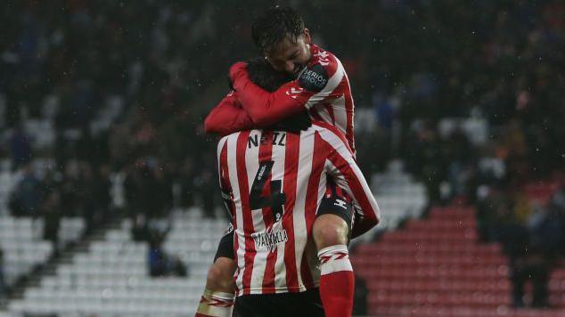 Patrick Roberts hugs Dan Neil