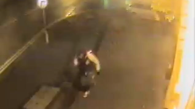 Overhead CCTV footage shows Ahsan walking down a lit-up street at night