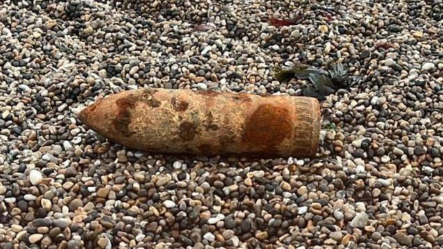 A shell on shingle, the shell is rusty 