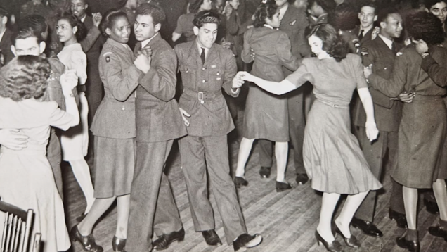 A black and white photograph from the 1940's showing people dancing, with the men, and some of the women, wearing RAF uniform.