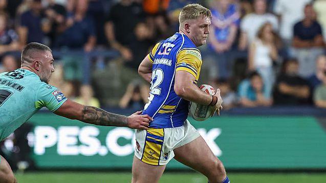 James McDonnell bursts through the St Helens defence for Leeds Rhinos