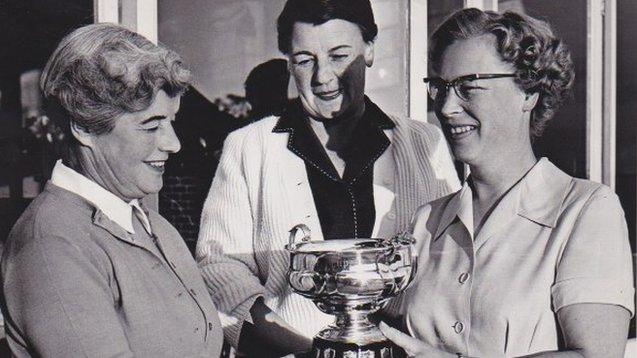 Woman receiving trophy