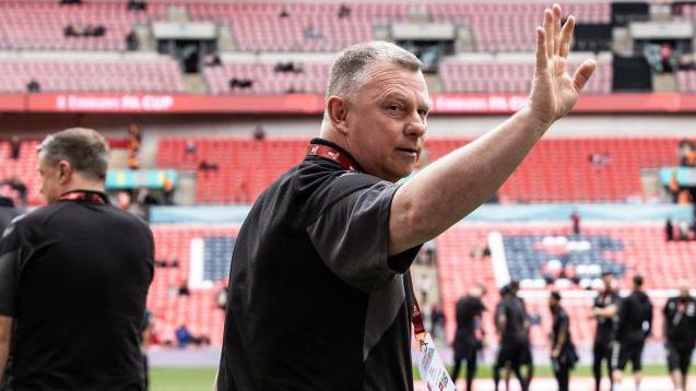 Mark Robins turns and waves to Coventry City fans