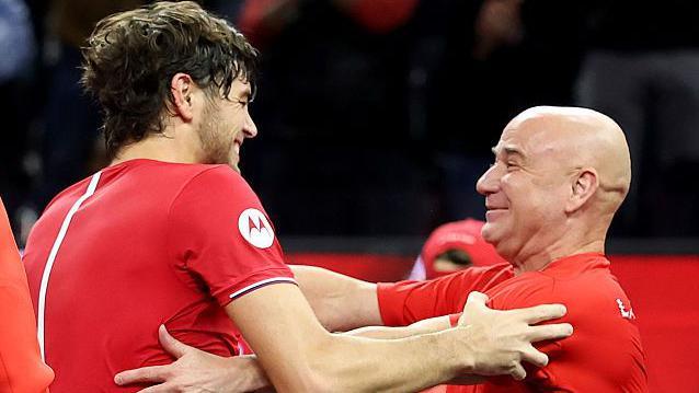 Taylor Fritz is embraced by Andre Agassi after Team World's win