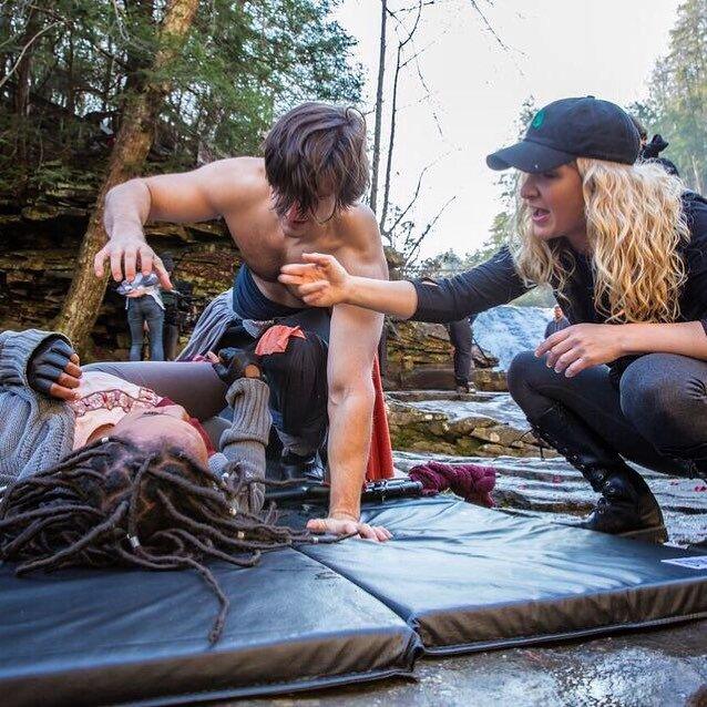 Alicia Rodis choreographing a scene with body contact between performers