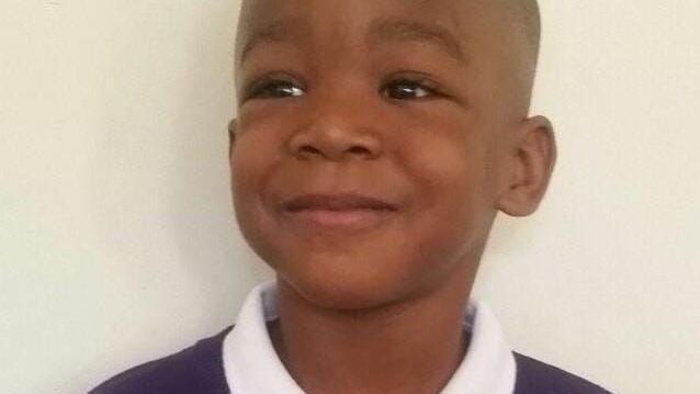 A photo of young boy in his school uniform.
