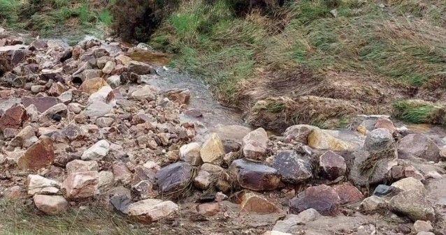 A jumble of rocks where the path was washed away